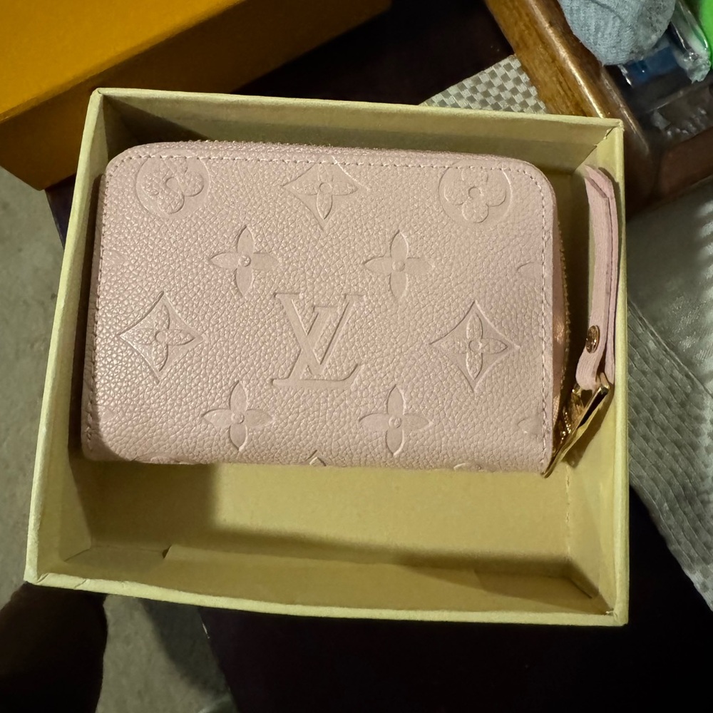 Pink Wallet with Embossed Design and Zipper Closure